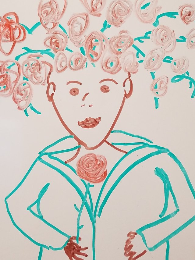 A whiteboard drawing of a woman with vines and roses for hair