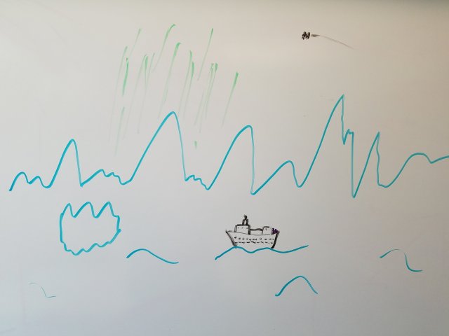 A cruise ship sails close to the Antarctic ice shelf, illuminated by the Aurora Australis while the International Space Station passes overhead